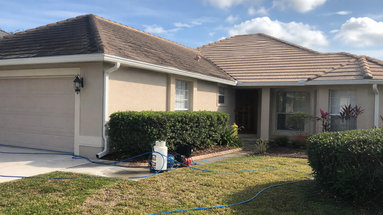 Soft wash roof cleaning for algae stains on an Orlando home